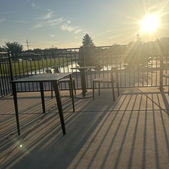 Starbucks - the sun setting over a patio with tables and chairs - Coffee & Tea Near Me - Flossmoor, Illinois