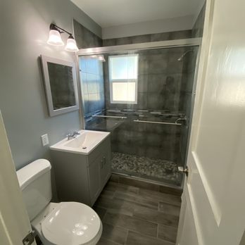 Herod Builders - a bathroom with a toilet, sink, and shower - General Contractors Near Me Herod Builders - a bathroom with a toilet, sink, and shower - General Contractors Near Me