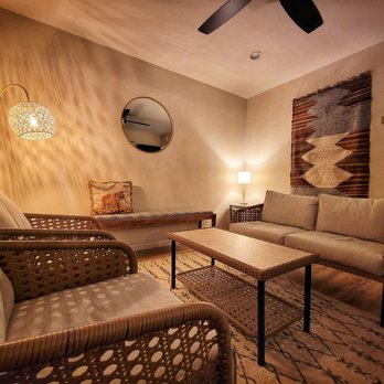 Cliff Dweller Winery - a living room with wicker furniture - Wine Tasting Room Near Me - Palisade, Colorado