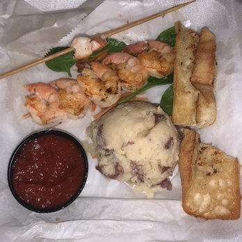 Mudbugs Cajun Kitchen - 2 skewers of shrimp. Small piece of toast - Cajun/Creole Near Me - Sanibel, Florida