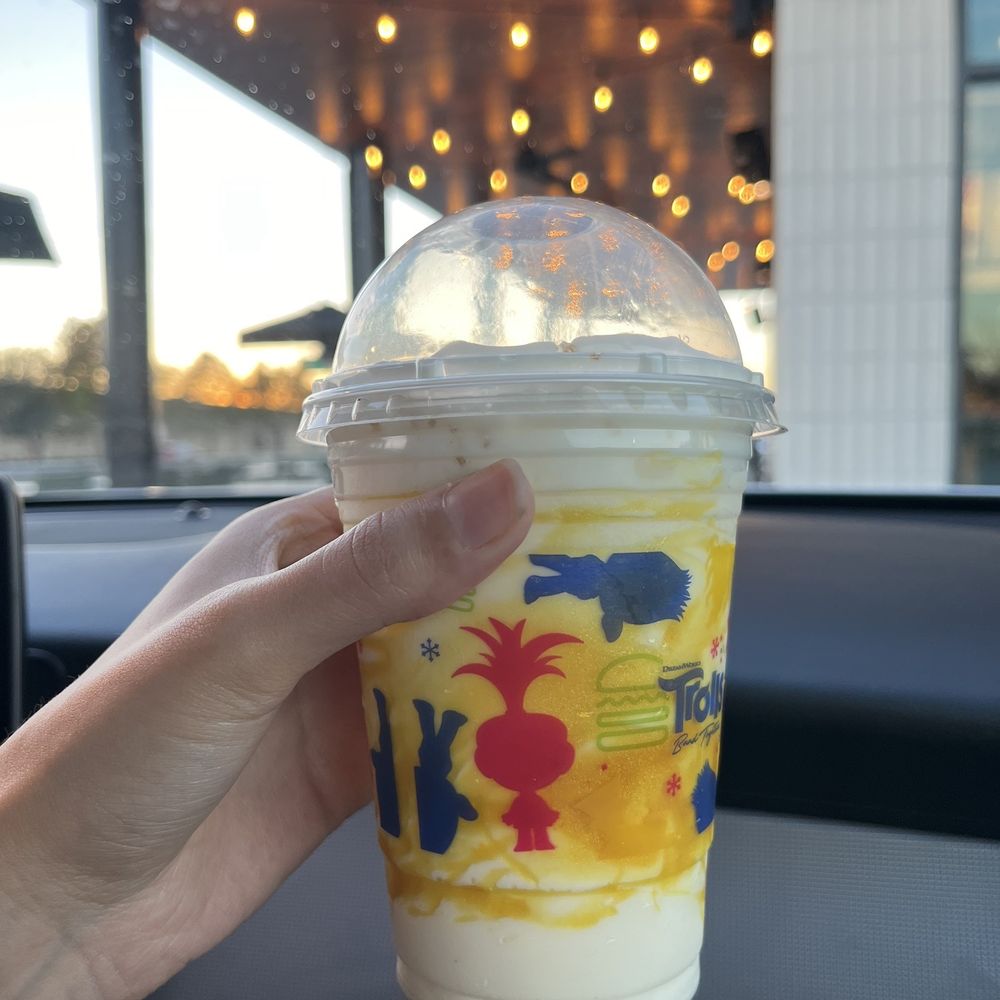 a hand holding a drink a hand holding a drink
