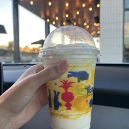 a hand holding a drink