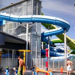 Waterworld - Outdoor splash area with water slides in the background