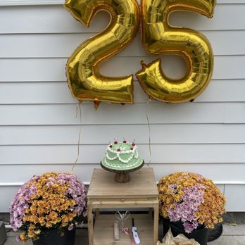 Dessert Designs - a table with a cake and balloons - Bakeries Near Me - Nashville, Tennessee