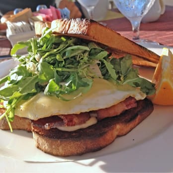 Fuego - Egg Sandwich $12: Over easy fried egg, gruyere, smoked bacon, arugula, garlic aioli on rustic white. - Mexican Near Me - Long Beach, California