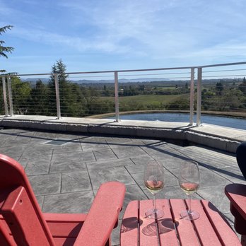 Overshine Wine - two red chairs and a glass of wine - Wineries Near Me - Healdsburg, California Overshine Wine - two red chairs and a glass of wine - Wineries Near Me - Healdsburg, California