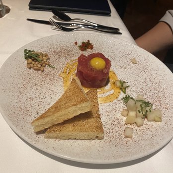 Michael Mina - Tuna tartare. The server mixes it up. Ends up tasting like poke. From signature menu. - New American Near Me - Las Vegas, Nevada Michael Mina - Tuna tartare. The server mixes it up. Ends up tasting like poke. From signature menu. - New American Near Me - Las Vegas, Nevada