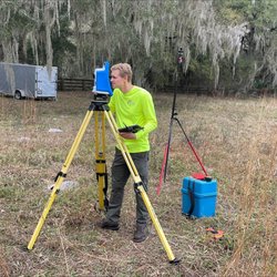 3002 Geospatial - Dale S. using the robotic total station in order to take measurements of a building