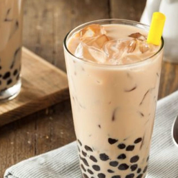 a glass of bubble tea on a table a glass of bubble tea on a table