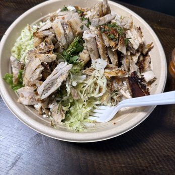 Zankou Chicken - Chicken bowl width rice lettuce and cabbage salad with a side of thei spicy sauce - Mediterranean Near Me - Long Beach, California Zankou Chicken - Chicken bowl width rice lettuce and cabbage salad with a side of thei spicy sauce - Mediterranean Near Me - Long Beach, California