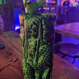Creepy mermaid mug with my drink. I was 80% tempted to buy it and take it home. Lots of booze and flavors in this one. Creepy mermaid mug with my drink. I was 80% tempted to buy it and take it home. Lots of booze and flavors in this one.