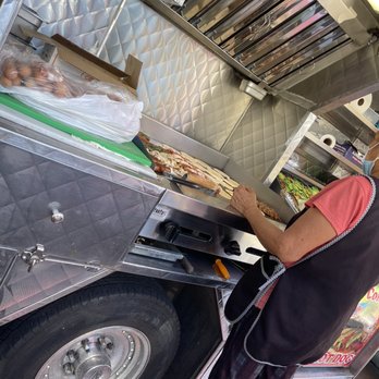 Jesus Hot Dogs - a man preparing food in a food truck - Food Trucks Near Me - Los Angeles, California