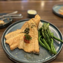 Ember and Elm - Rainbow Trout topped with a lemon caper brown-butter sauce served with grilled seasoned green beans and Carolina Gold rice.