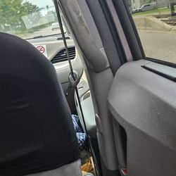 Blue and White Taxi - If you look down you can see all the trash on the passenger side floor gross and look at the handle to use to get into the van nasty