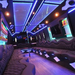 Paramount Limousine - Spacious party bus interior with colorful lighting for an unforgettable group experience.