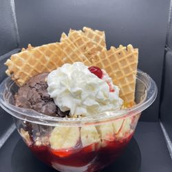 Space Coast Ice Cream - Our signature Chris' Colossal Sundae! Fresh baked brownie, bananas, waffle cone nachos, three scoops of ice cream, three syrups, and whip.