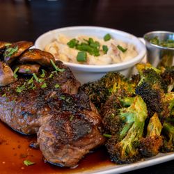 Sierra Grill - Wood fire grilled ribeye, smashed potatoes, roasted mushrooms and broccolini
