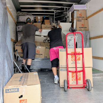 Hoss Movers - This is the guys trying to keep everything from falling forward because the base had collapsed under the weight. They saved everything! - Movers Near Me - Bay City, Michigan