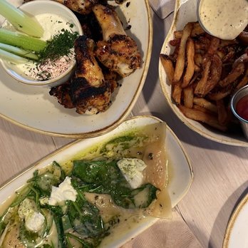 Monkeypod Kitchen by Merriman - Drinks: Mai Thai, one in a melon;  Food top down; Wood - Roasted Chicken Wings, Garlic Truffle Oil Fries , Pumpkin Patch Ravioli - New American Near Me - Kihei, Hawaii