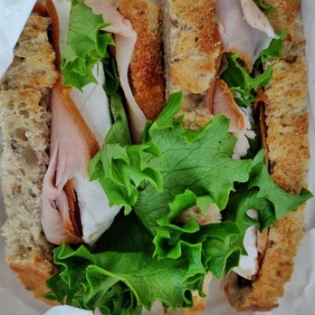 Fromagination - The signature sandwich, turkey, brie and cranberry spread with lettuce on sunflower bread - Cheese Shops Near Me - Madison, Wisconsin