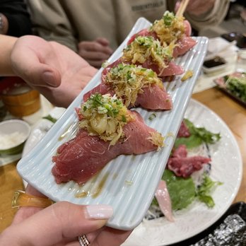 Kanbai Sushi - a person holding a plate of food - Sushi Bars Near Me - Los Angeles, California Kanbai Sushi - a person holding a plate of food - Sushi Bars Near Me - Los Angeles, California