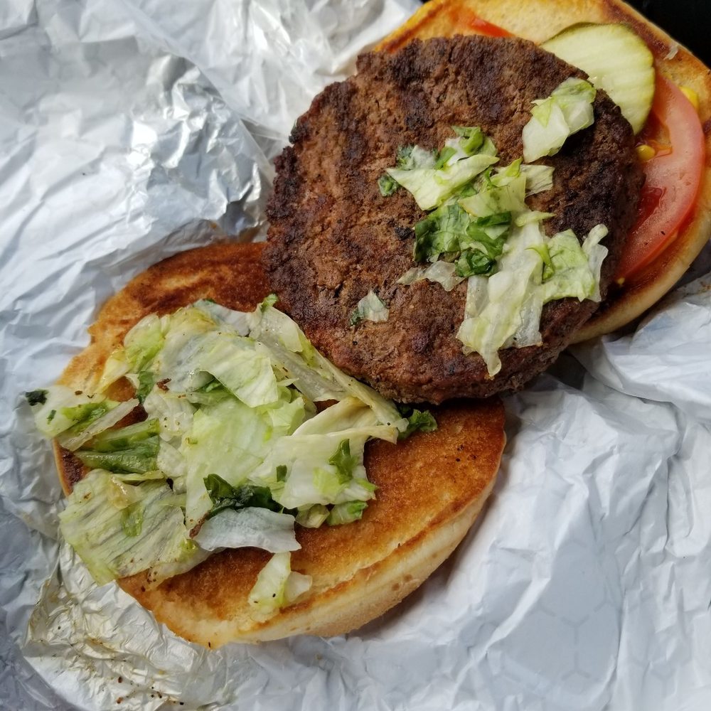 a hamburger with lettuce and tomato a hamburger with lettuce and tomato