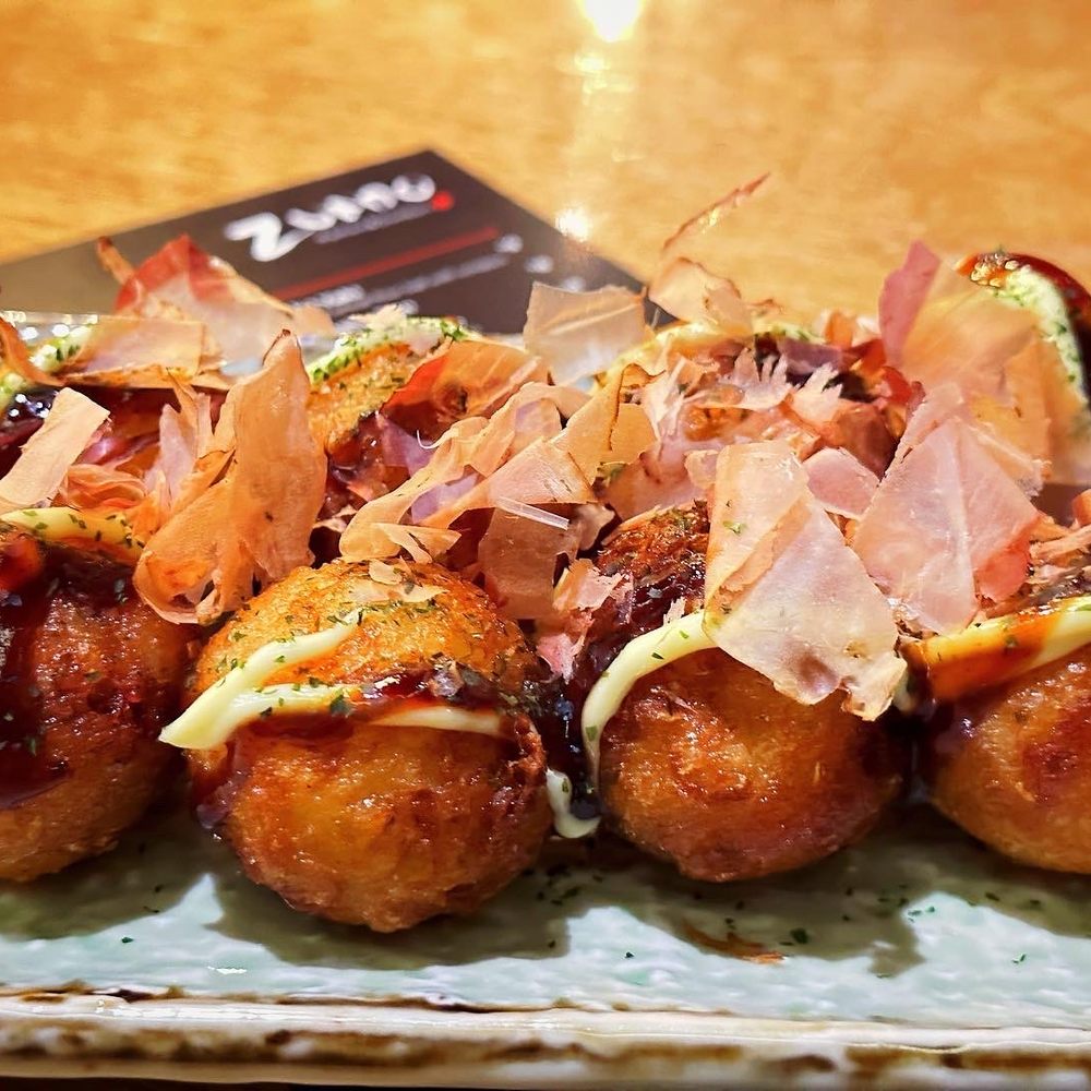 Zundo Ramen & Donburi - Tako Yaki fried octopus wheat flour balls with sauces on top. - Bars Near Me - Jackson, Mississippi Zundo Ramen & Donburi - Tako Yaki fried octopus wheat flour balls with sauces on top. - Bars Near Me - Jackson, Mississippi