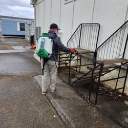 Critter Wranglers Pest and Wildlife Control - Pest control technician applying an exterior pesticide treatment.