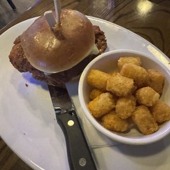 The District Tap Downtown - Buffalo Chicken Sandwich with Tater Tots - American Near Me - Indianapolis, Indiana The District Tap Downtown - Buffalo Chicken Sandwich with Tater Tots - American Near Me - Indianapolis, Indiana