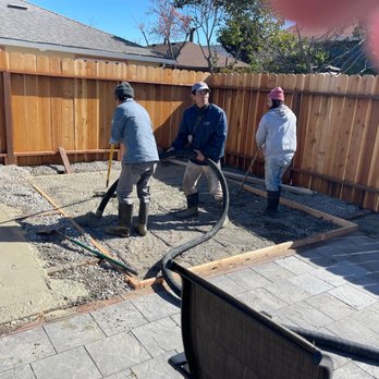 Pham's Landscape & Concrete Services - Preparing cement foundations and fence in the background by Pham family - Landscaping Near Me