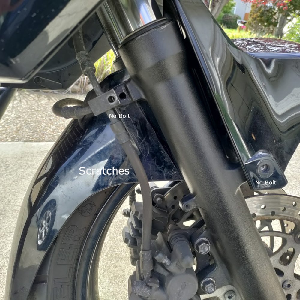 Two bolts that came loose on the freeway (fender and brake line). Scratches all over the fender. Two bolts that came loose on the freeway (fender and brake line). Scratches all over the fender.