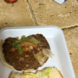 Hank's Fish Market - The burger with a half a tomato and 2 pickles.