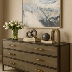 Annabelle's Fine Furniture & Interior Design - Stylish vignette featuring a modern dresser, sculptural decor, fresh florals, and a sweeping abstract painting.