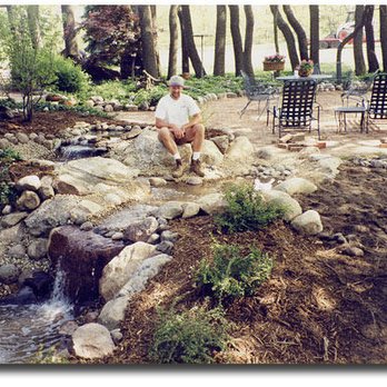 Klooster Landscaping - a man and his dog sitting on a rock - Landscaping Near Me - Richland, Michigan