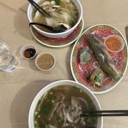 Bowls of pho and a garden role with chicken. Bowls of pho and a garden role with chicken.