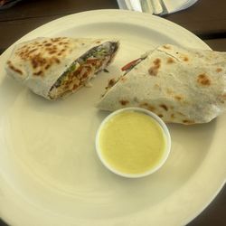 Bo's Burrito with chicken, black beans, bell peppers, grilled onions, lettuce and tomato in a wheat tortilla