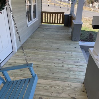 Grindstone Renovations - a porch swing on a porch - Decks & Railing Near Me - Newport, Tennessee