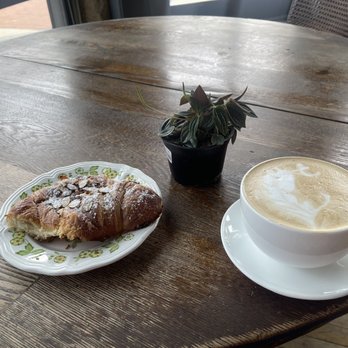 Flying M Coffeeshop - Almond croissant, caramel latte, and a little plant I picked up next door. - Coffee & Tea Near Me - Caldwell, Idaho Flying M Coffeeshop - Almond croissant, caramel latte, and a little plant I picked up next door. - Coffee & Tea Near Me - Caldwell, Idaho