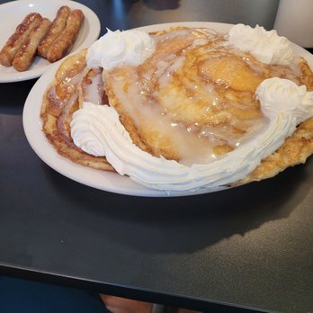 Campfire Grill - "Hill" of Cinnamon Roll Hotcakes, and 4 links of sausage. - American Near Me - Depew, New York Campfire Grill - "Hill" of Cinnamon Roll Hotcakes, and 4 links of sausage. - American Near Me - Depew, New York