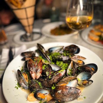 Emerson's - a plate of steamed mussels on a table - Cocktail Bars Near Me - Pittsburgh, Pennsylvania