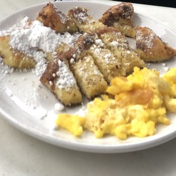 Another Broken Egg Cafe - French Toast Scrambler from kids menu. French Toast Scrambler-Came with a strip of bacon and syrup. We asked for extra powdered sugar. - Breakfast & Brunch Near Me - Oviedo, Florida