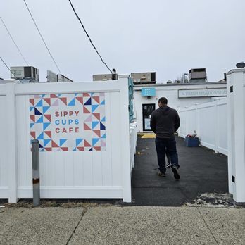 Sippy Cups Cafe - Entrance to Sippy Cups Cafe from the back. There is free parking in the back. - Cafes Near Me - Seaford, New York