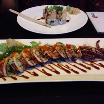 Amaze - Top of photo: Shrimp tempura roll. That big boy? Giant Squid Roll. Yup. Grill squid is the casing. Sushi innards put inside! - Lounges Near Me - New York, New York
