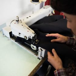 7TILL8 Custom Wetsuits - Andrew on the sewing machine making changes to a customers wetsuit.