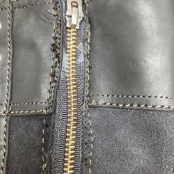 Essex Shoe Service - New zipper. Crooked and used a yellow thread. That I see after cleaning the bleed dye.