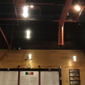Nico & Ana's - Bright rods of light spill down on the large menus that hang on the wall. - Italian Near Me - Overland Park, Kansas