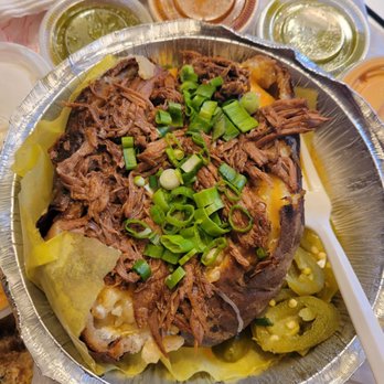 La Grana Fish - Loaded Stuffed Baked Potato, with Shredded Birria Beef, in takeout container, and lots of sauces - Seafood Near Me - Oakland, California La Grana Fish - Loaded Stuffed Baked Potato, with Shredded Birria Beef, in takeout container, and lots of sauces - Seafood Near Me - Oakland, California