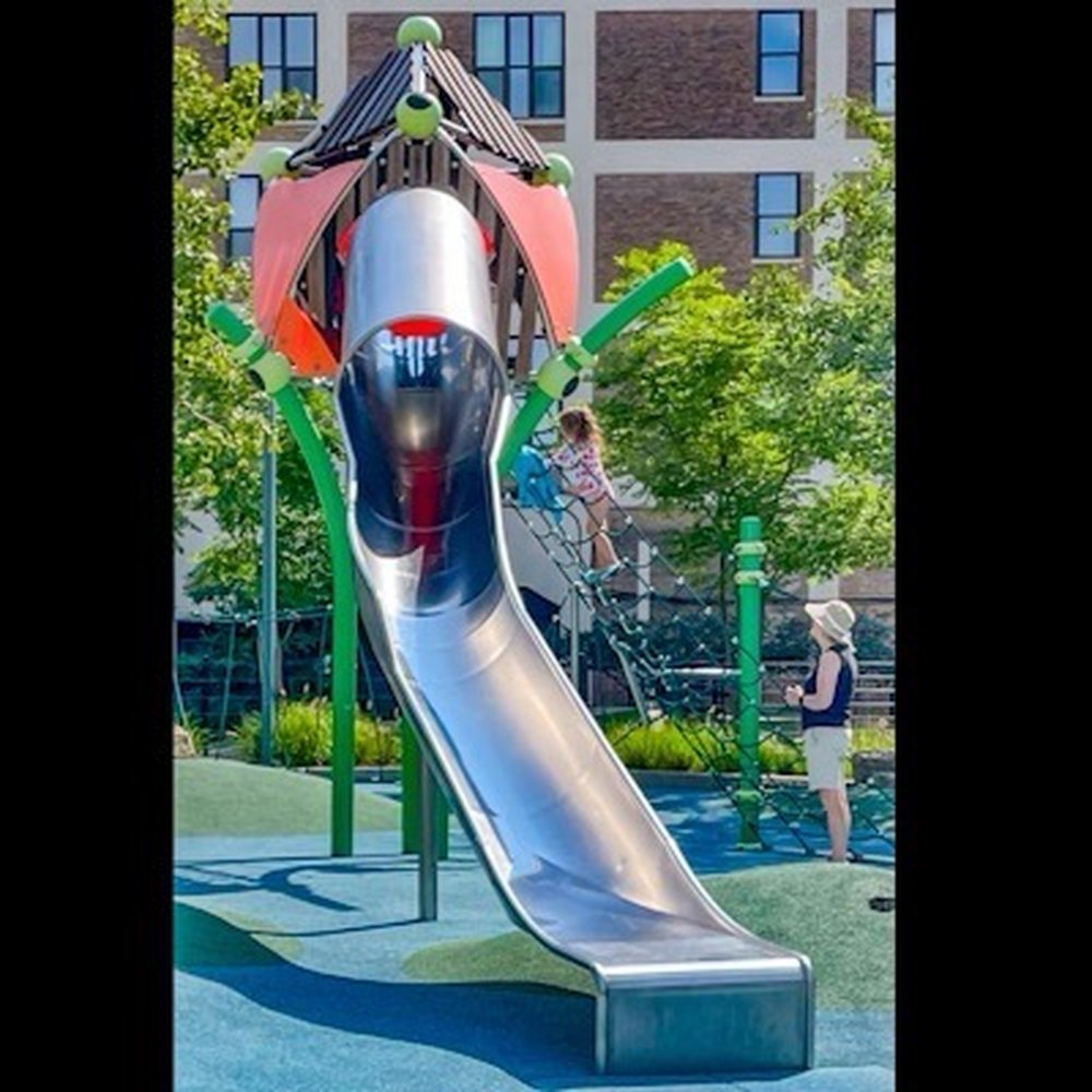 Prairie District Park - The big slide, with a net to climb, and an enclosure and tunnel at the top end - Water Parks Near Me - Chicago, Illinois Prairie District Park - The big slide, with a net to climb, and an enclosure and tunnel at the top end - Water Parks Near Me - Chicago, Illinois