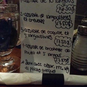 Santorini - a menu on a table at a restaurant - Mediterranean Near Me - Thetford Mines, Quebec Santorini - a menu on a table at a restaurant - Mediterranean Near Me - Thetford Mines, Quebec