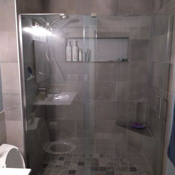 Seno Construction - a bathroom with a shower, toilet and sink - General Contractors Near Me